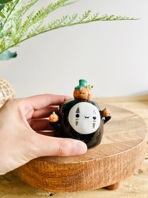 No Face with pumpkin friends bud vase