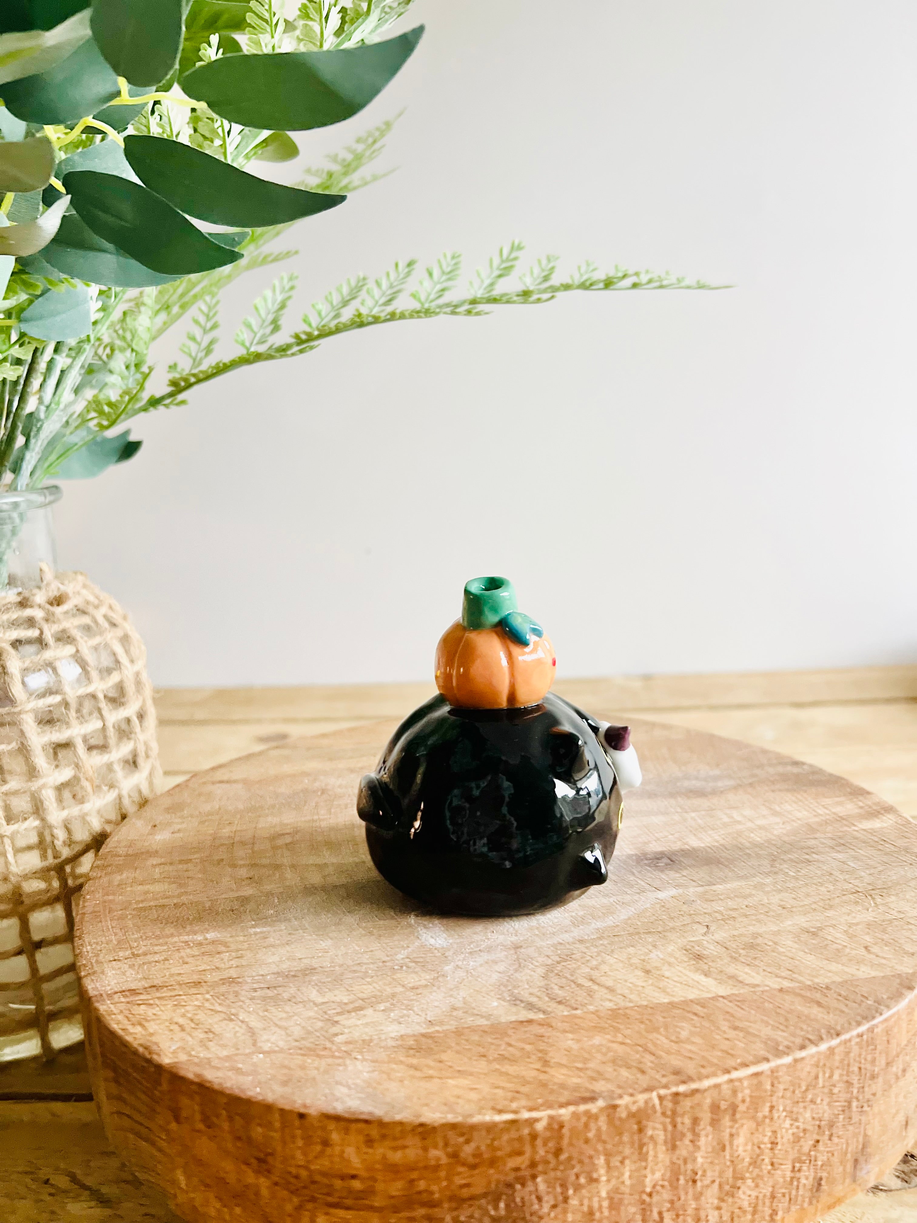 Sideways black cat with ghost and pumpkin friend bud vase