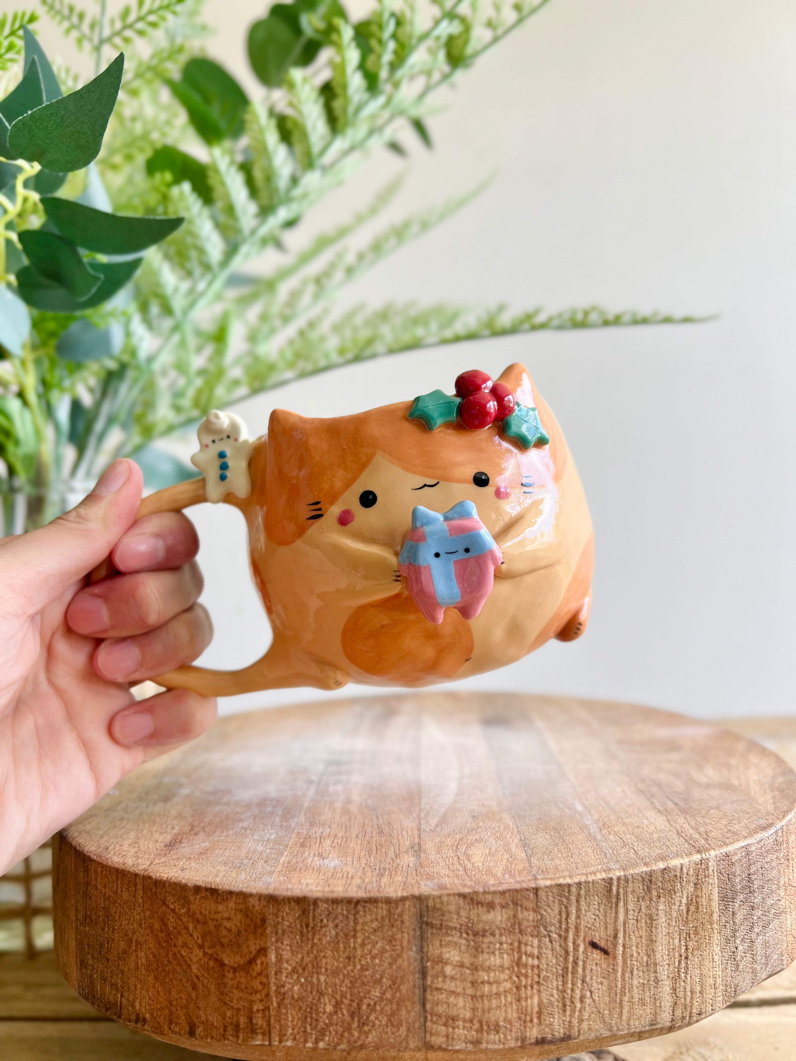 Festive gift bearing ginger cat mug with gingerbread friend