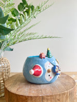 Festive sideways penguin pot with Christmas friends