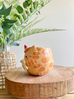 Ginger cat mug with gingerbread and present friend