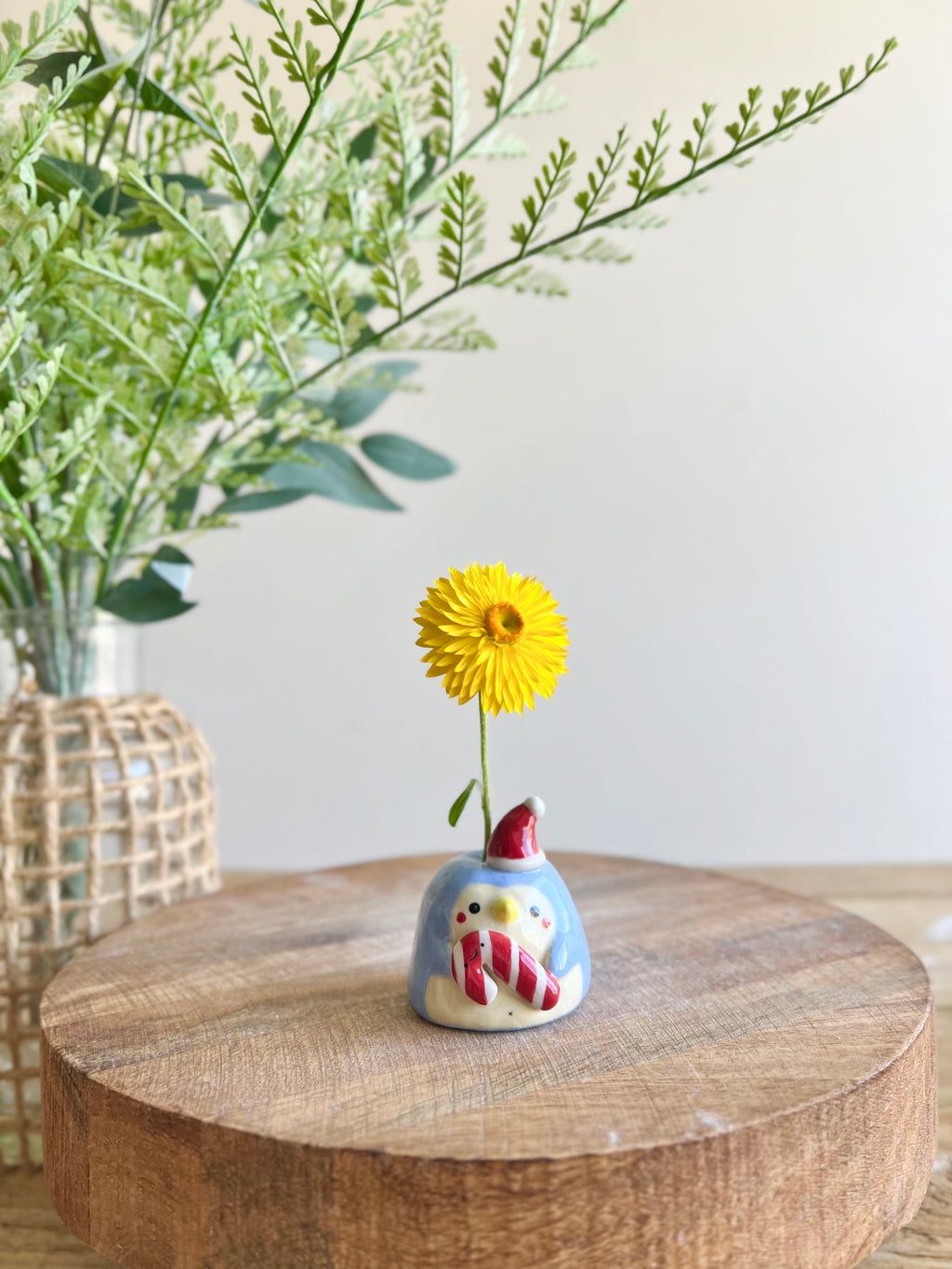 Mini festive penguin bud vase with candy cane friend