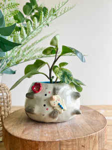 Flowery sideways bunny pot with gingerbread friend