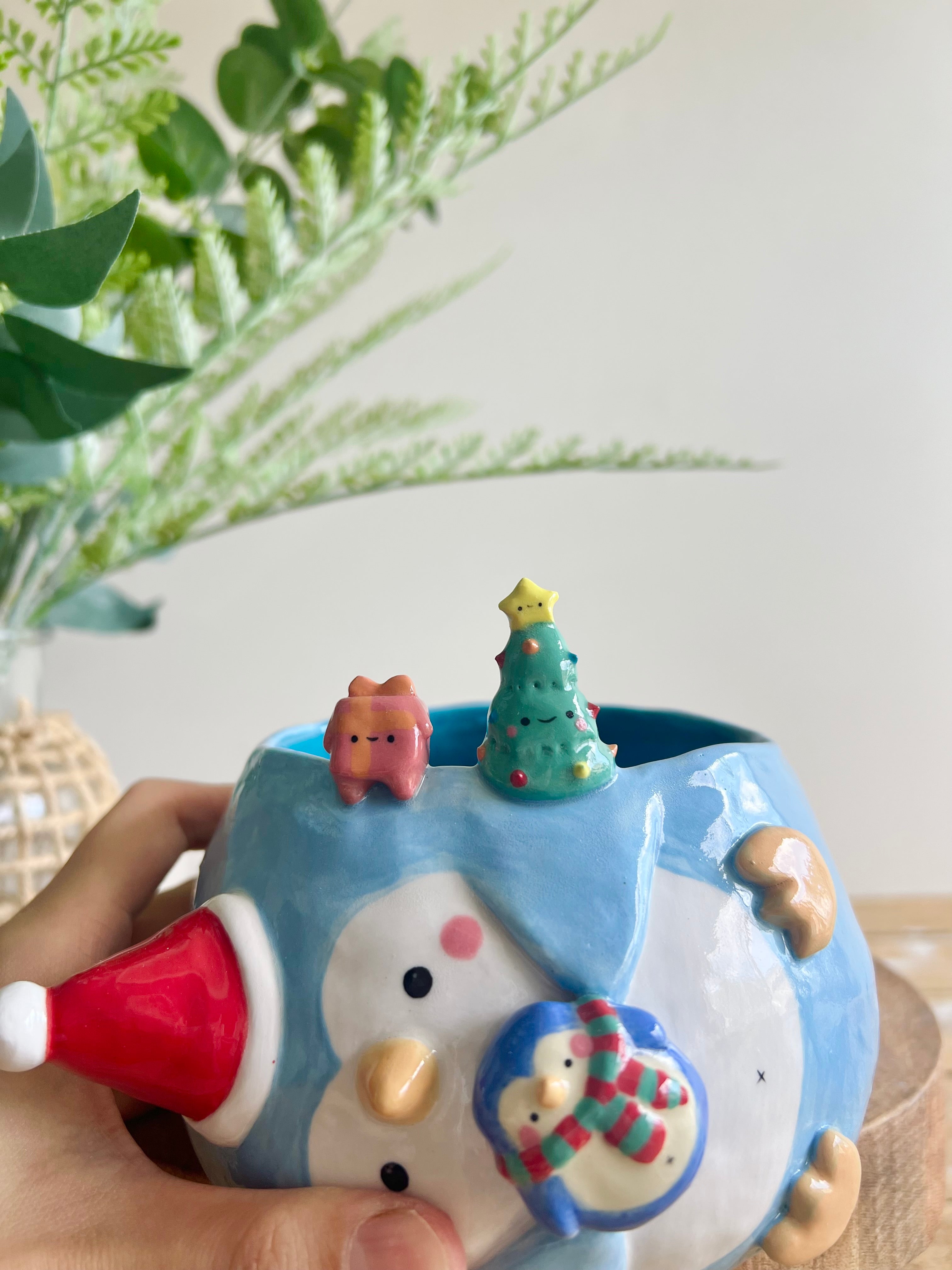 Festive sideways penguin pot with Christmas friends