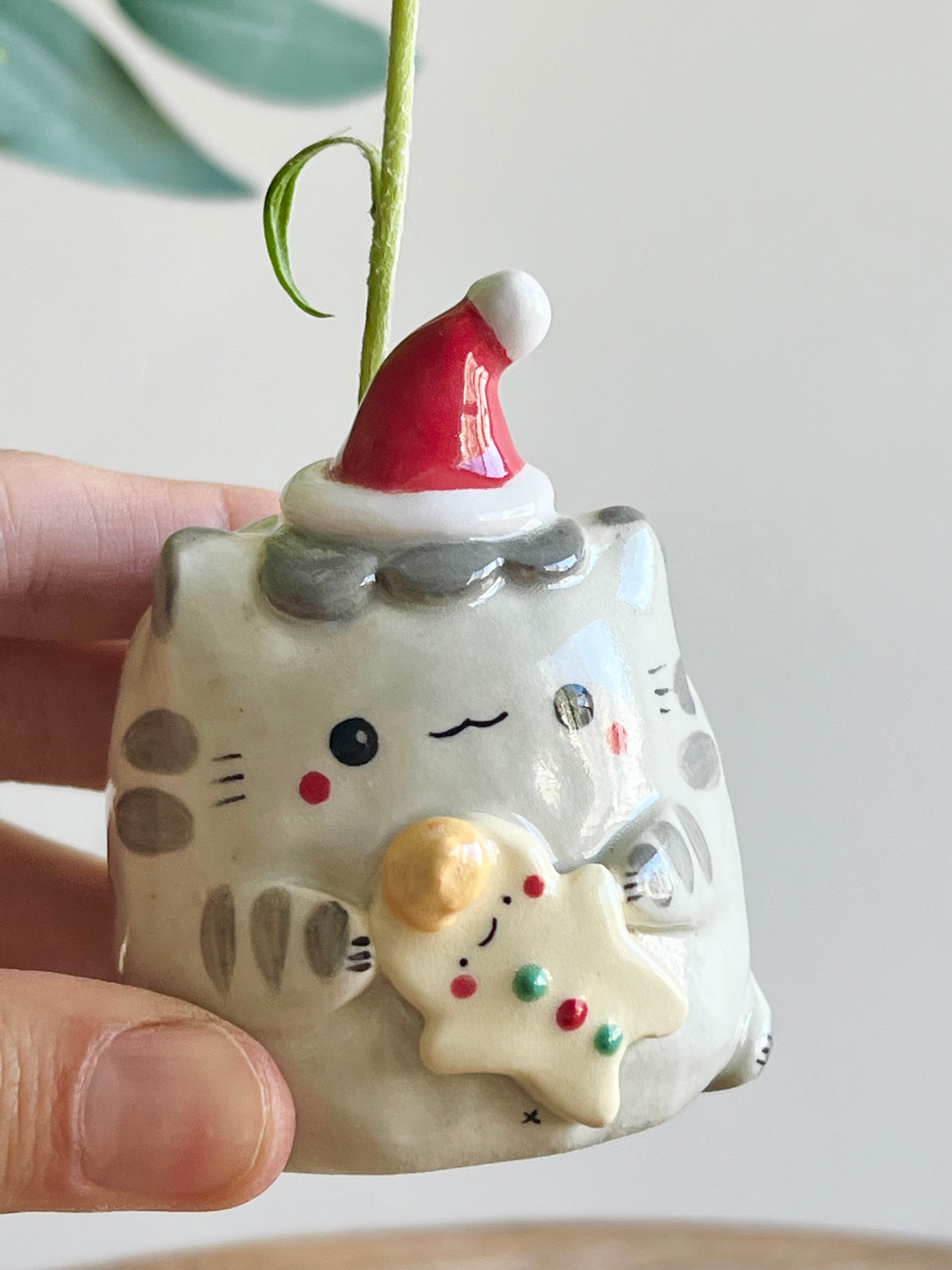 Festive grey cat with gingerbread friend bud vase