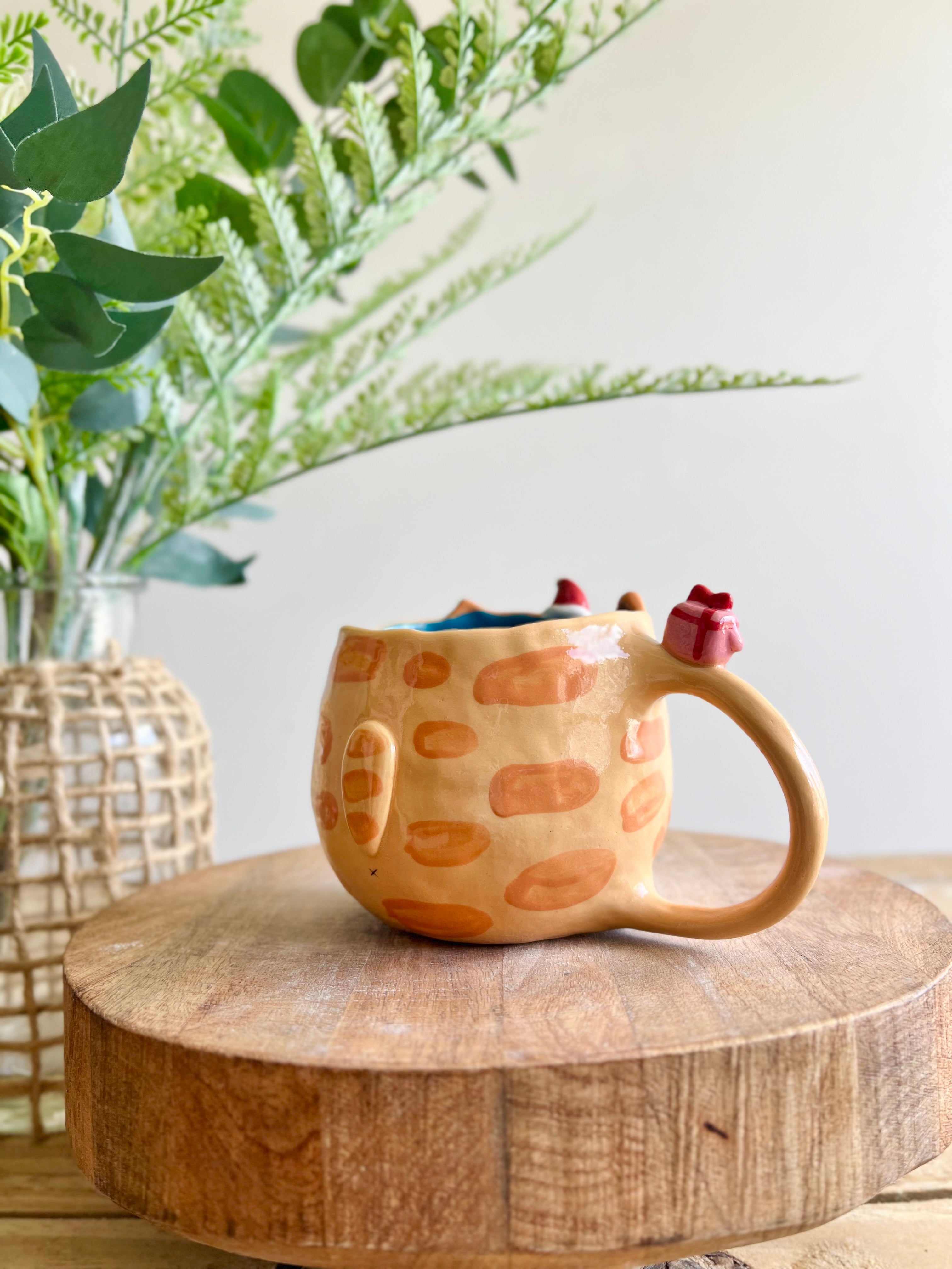 Ginger cat mug with gingerbread and present friend