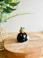 Sideways black cat with ghost and pumpkin friend bud vase