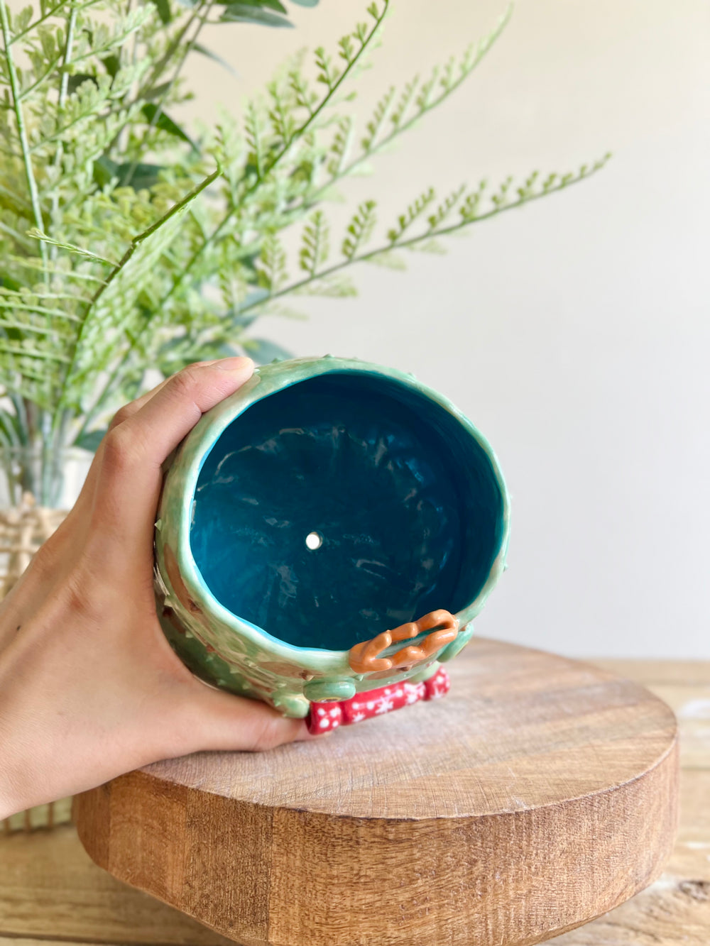 Festive grumpy Froggo planter cracks bon bon with you, photo 10 of 12