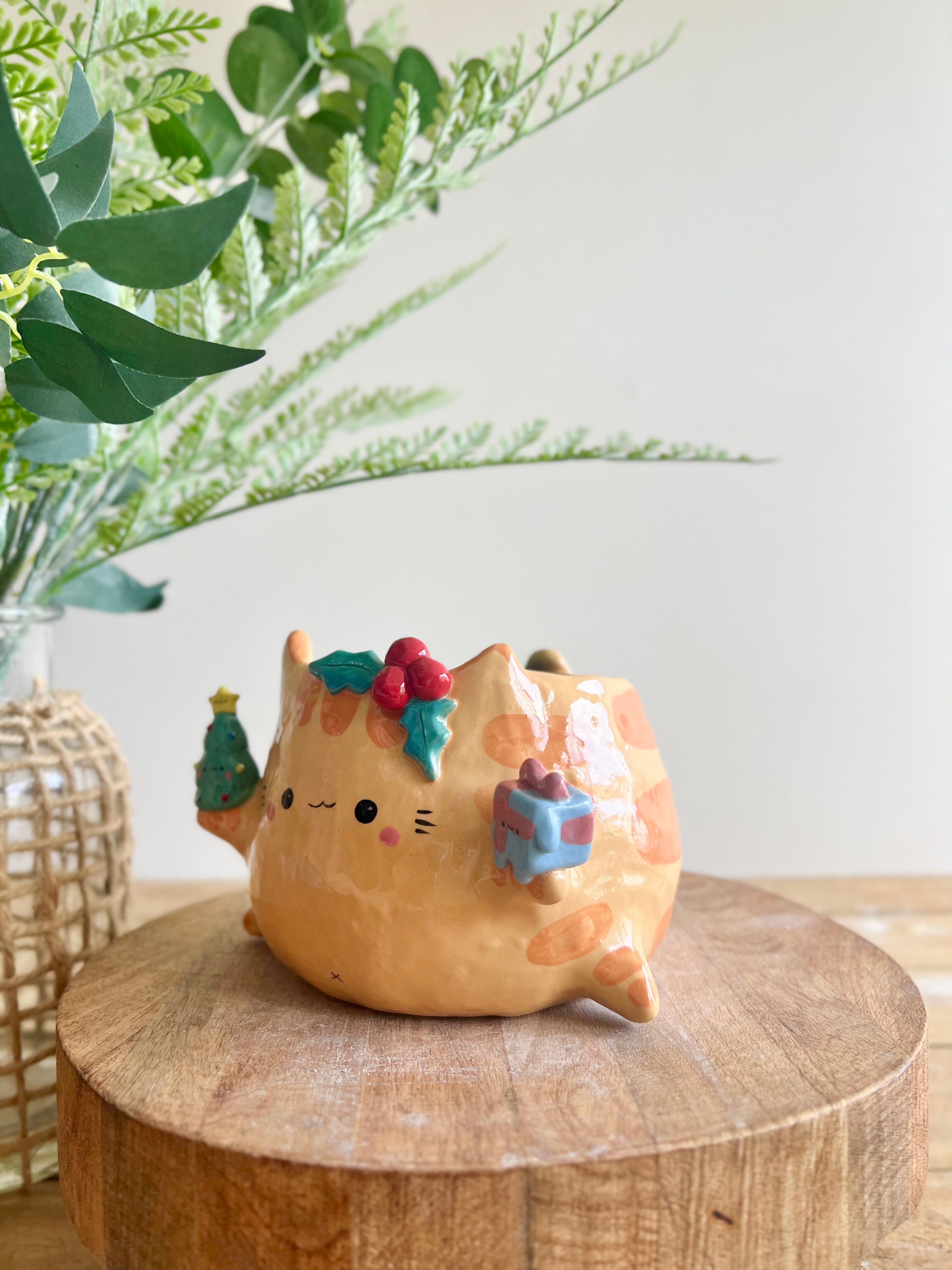 Gift bearing festive Ginger cat pot with Christmas tree friend