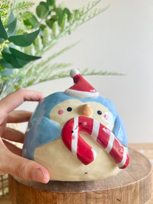 Festive penguin pot with giant candy cane friend