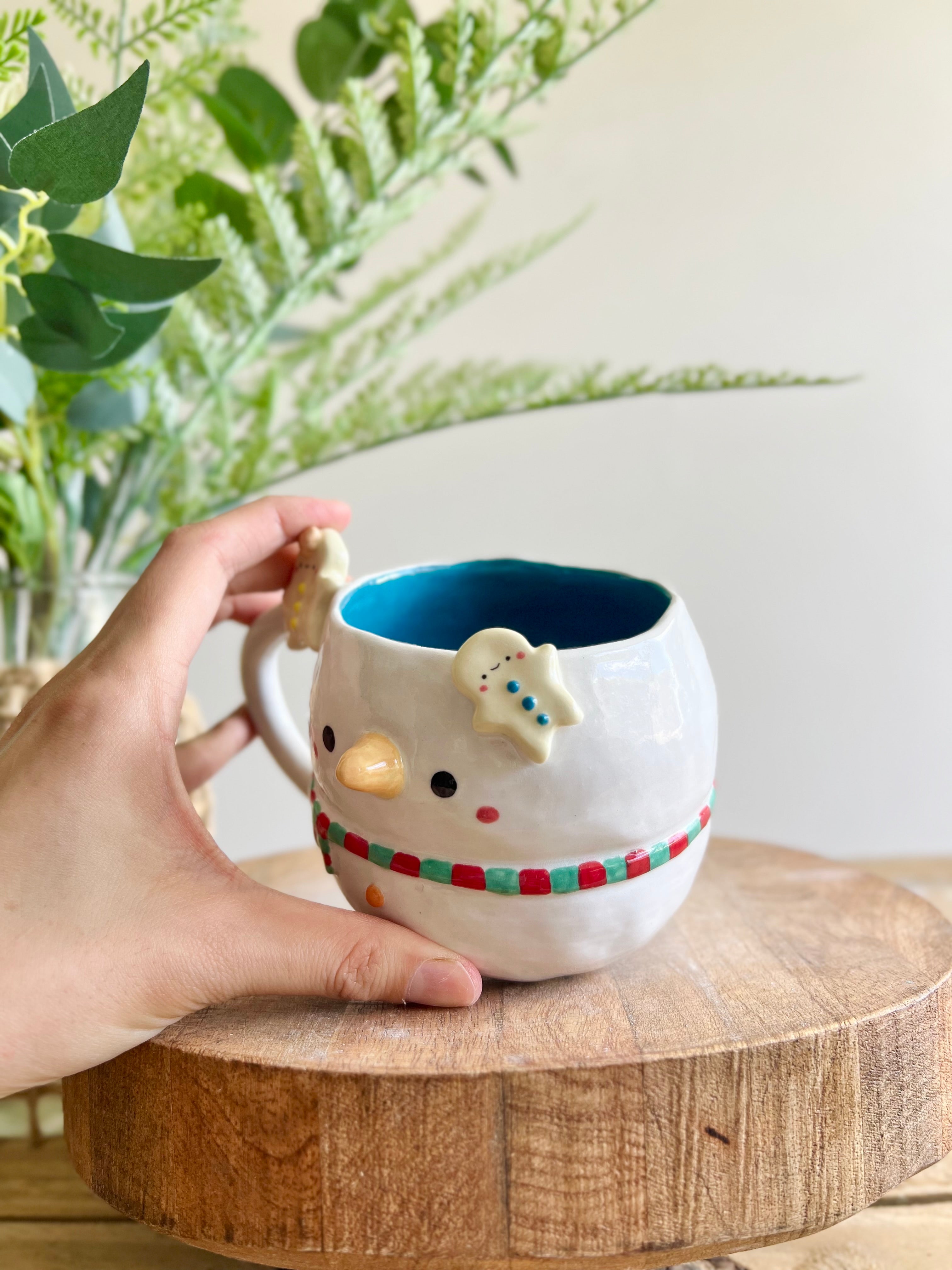 Snowman mug with gingerbread friends