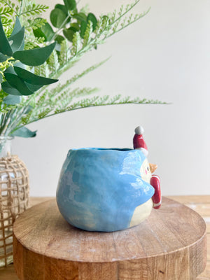 Festive penguin pot with giant candy cane friend