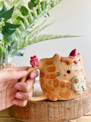 Ginger cat mug with gingerbread and present friend