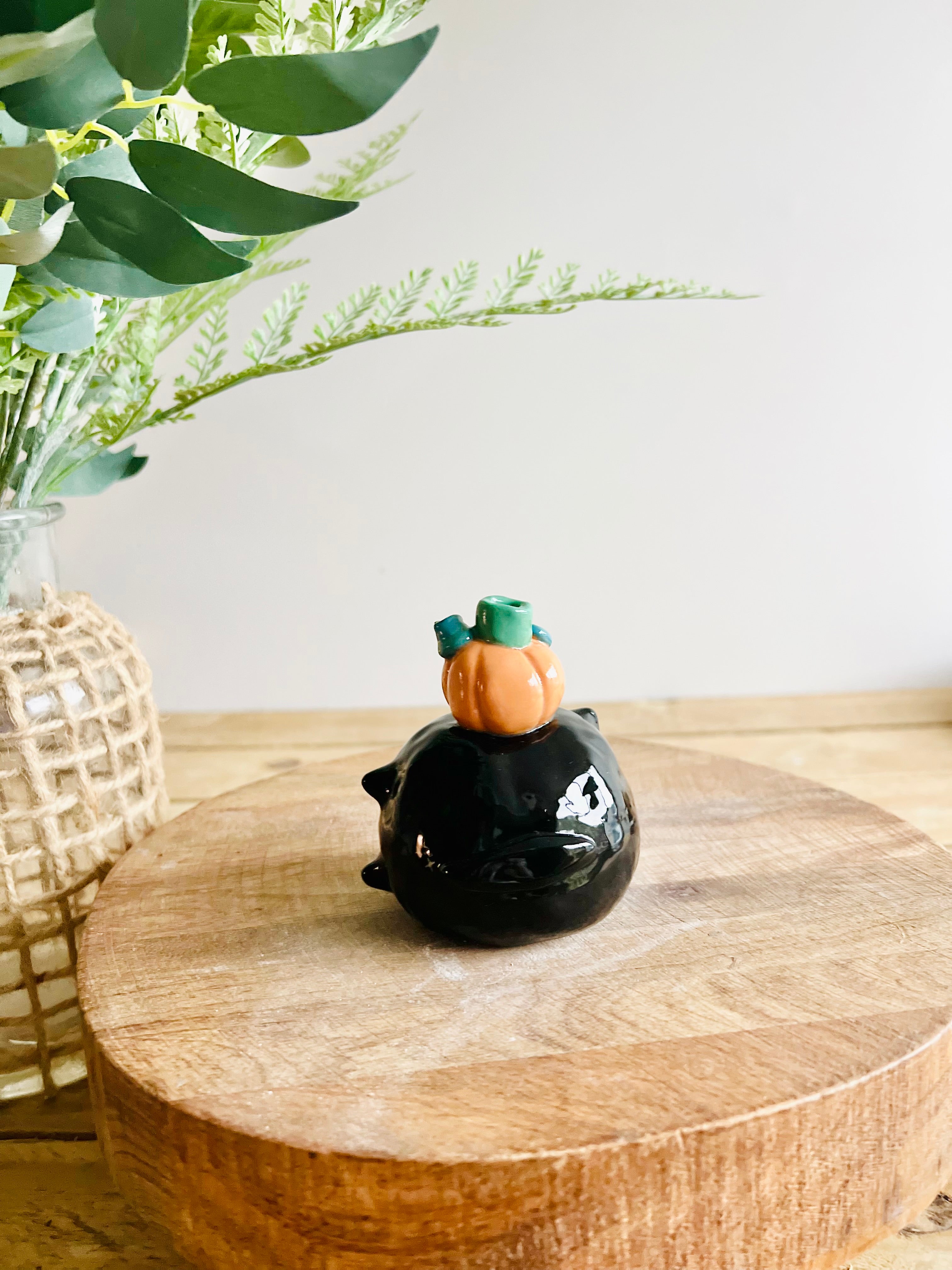 Sideways black cat with ghost and pumpkin friend bud vase