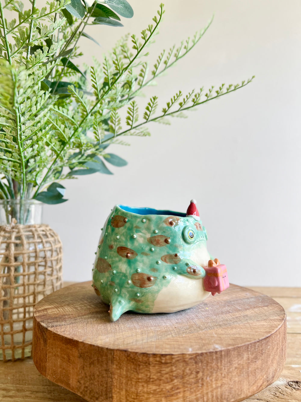 Festive grumpy Froggo planter bearing gift, photo 3 of 15