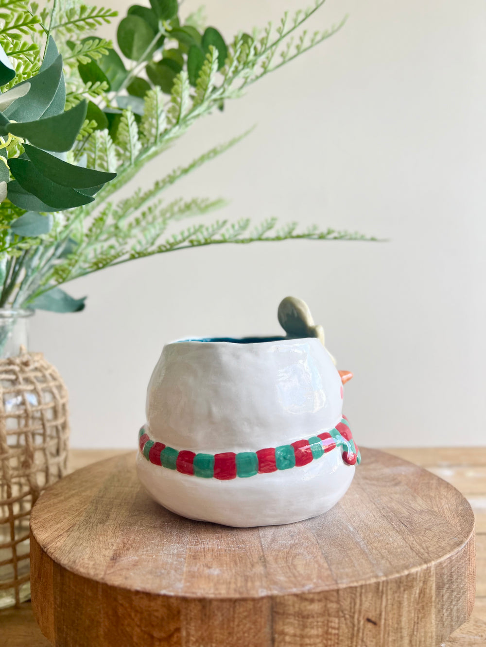 Festive snowman pot with gingerbread friend just chillin’ on its head, photo 3 of 11