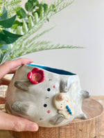 Flowery sideways bunny pot with gingerbread friend