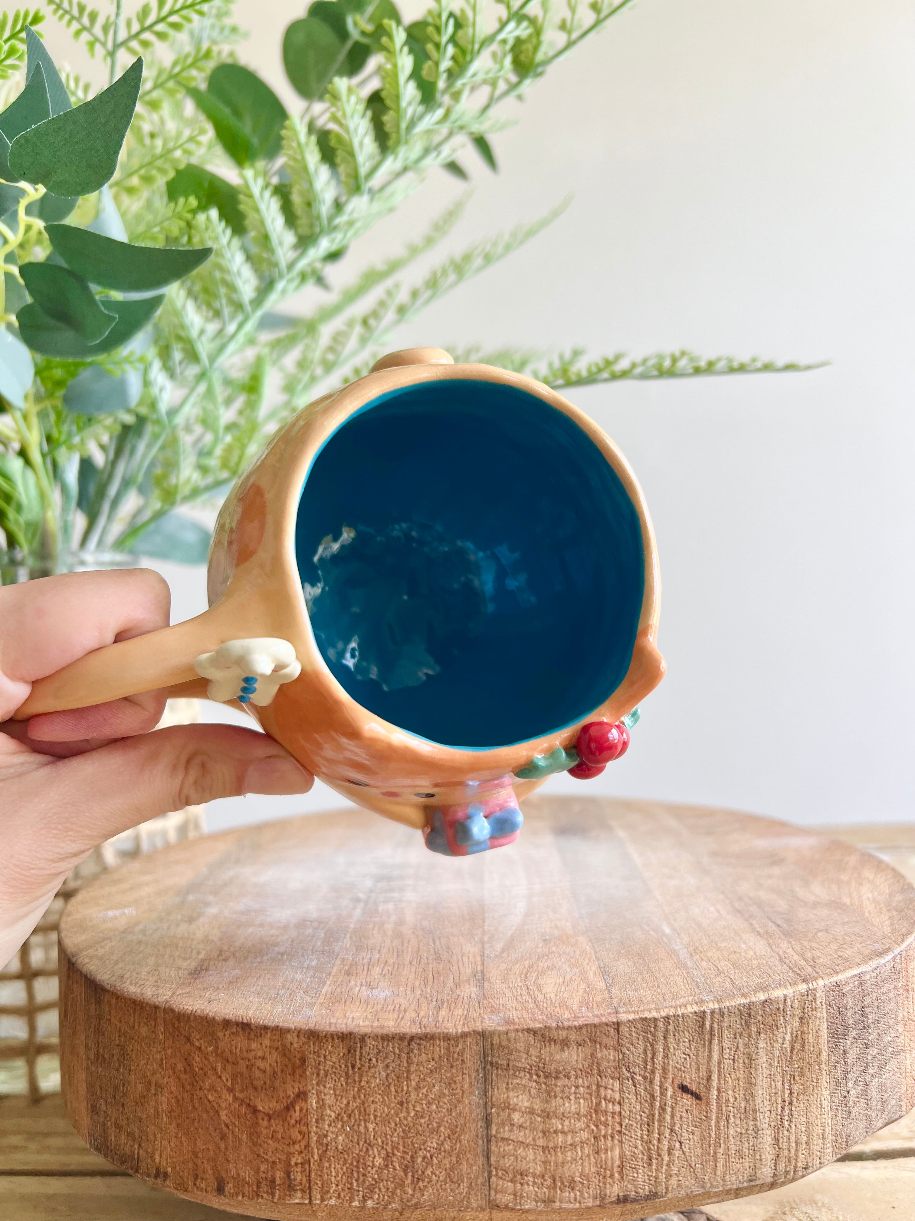 Festive gift bearing ginger cat mug with gingerbread friend