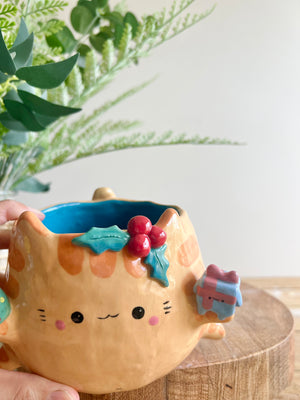 Gift bearing festive Ginger cat pot with Christmas tree friend