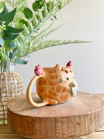 Ginger cat mug with gingerbread and present friend