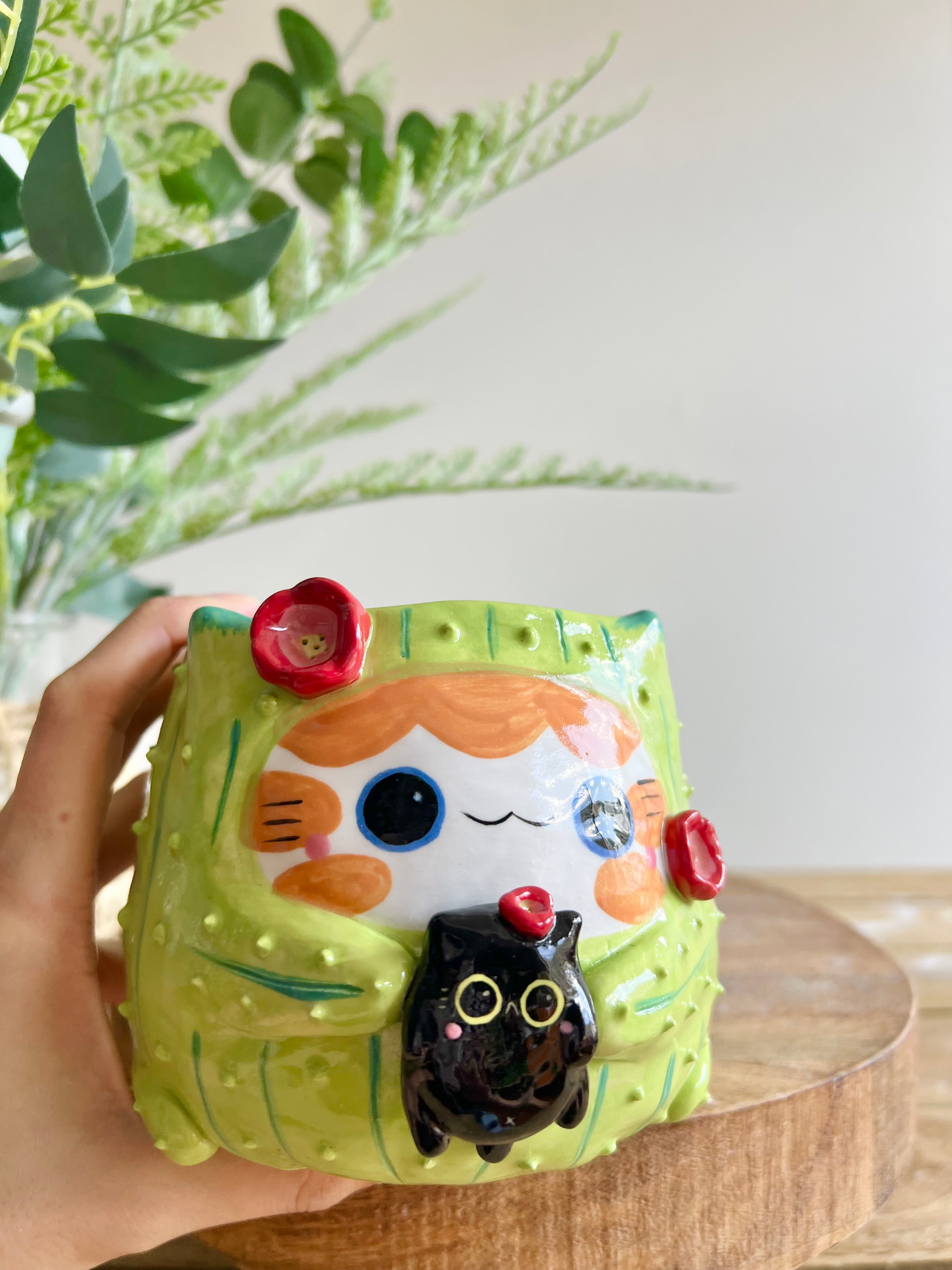 Flowery ginger CAT-us pot with black cat friend