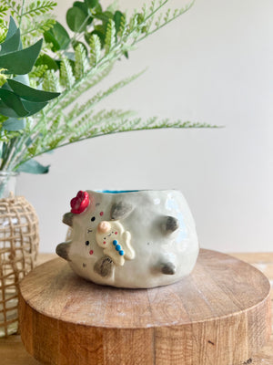 Flowery sideways bunny pot with gingerbread friend