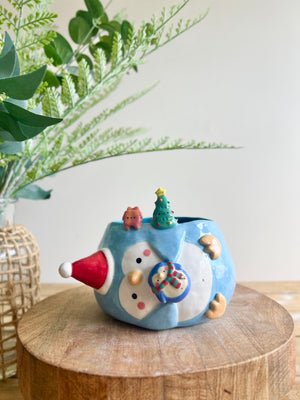 Festive sideways penguin pot with Christmas friends