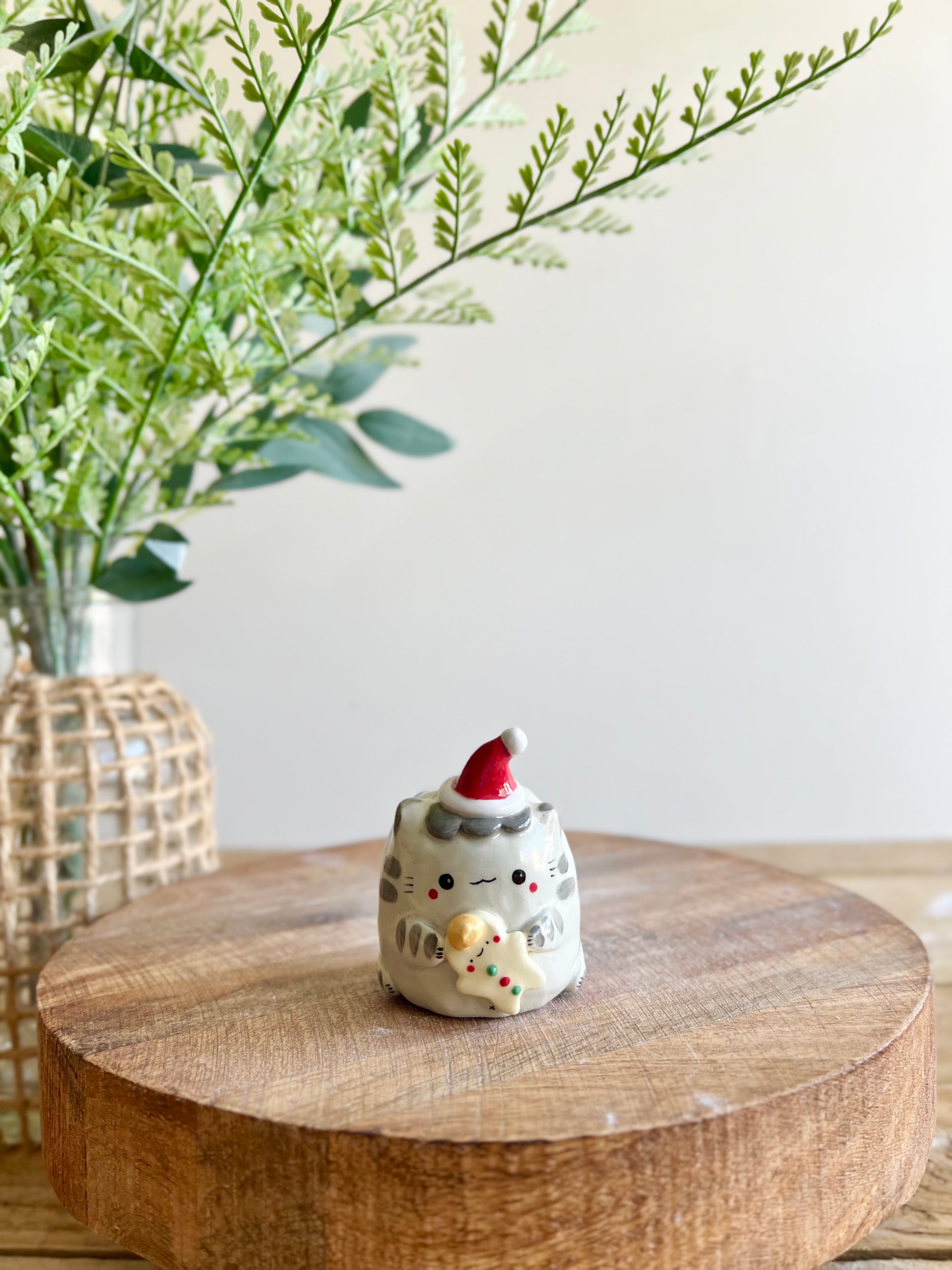 Festive grey cat with gingerbread friend bud vase