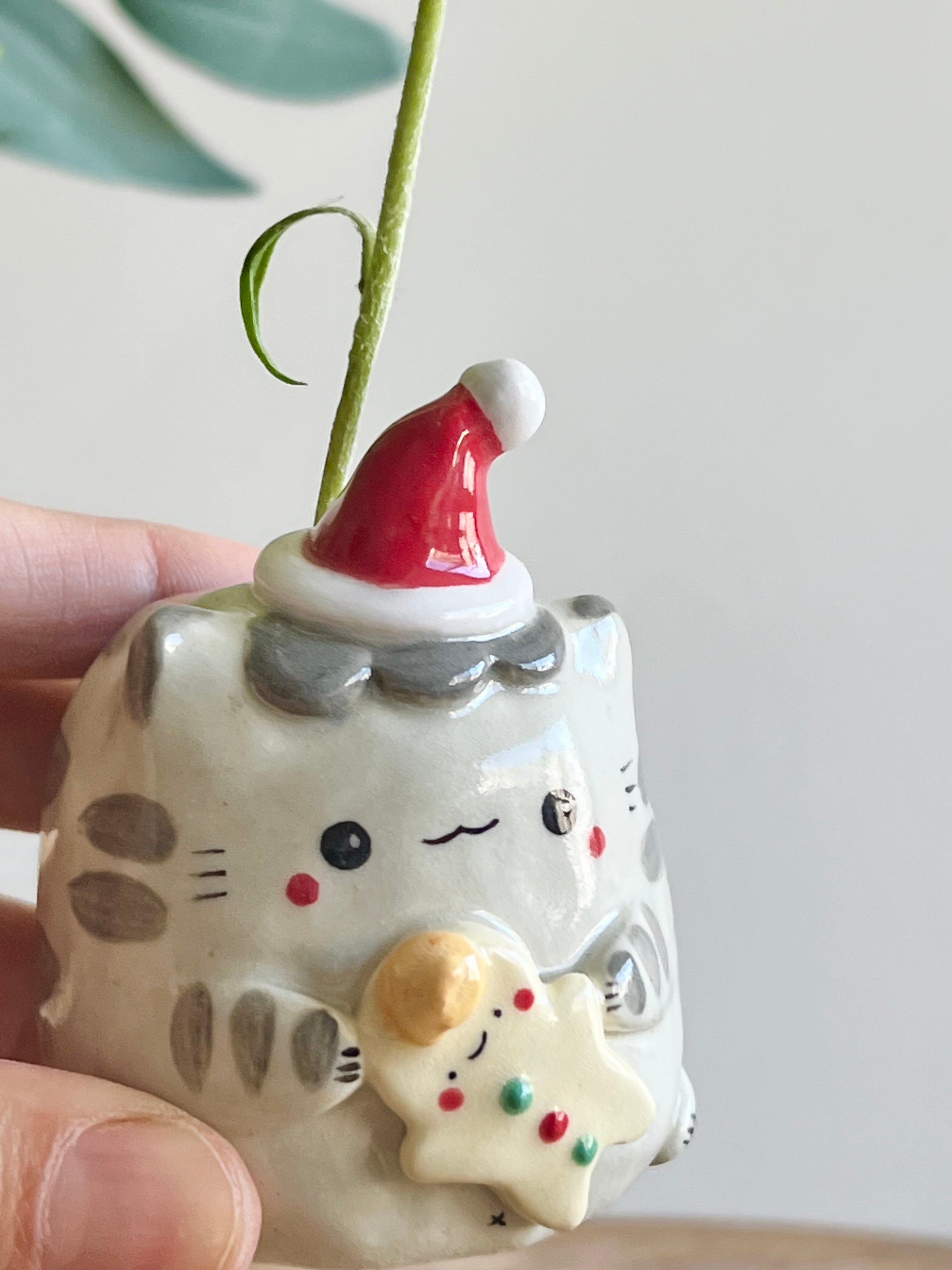 Festive grey cat with gingerbread friend bud vase