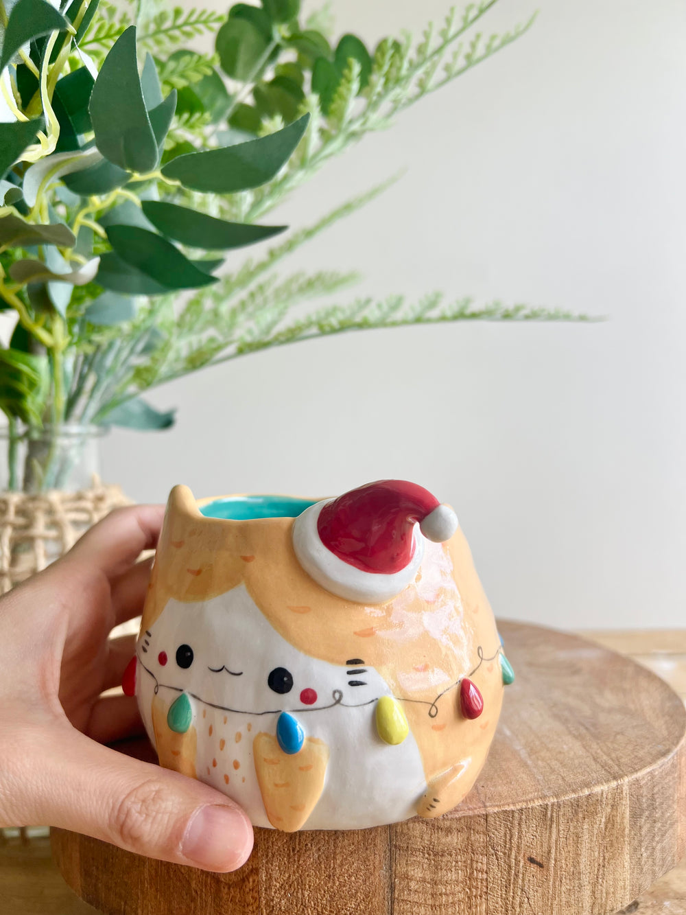 Festive ginger cat pot adorned with Christmas lights, photo 9 of 12