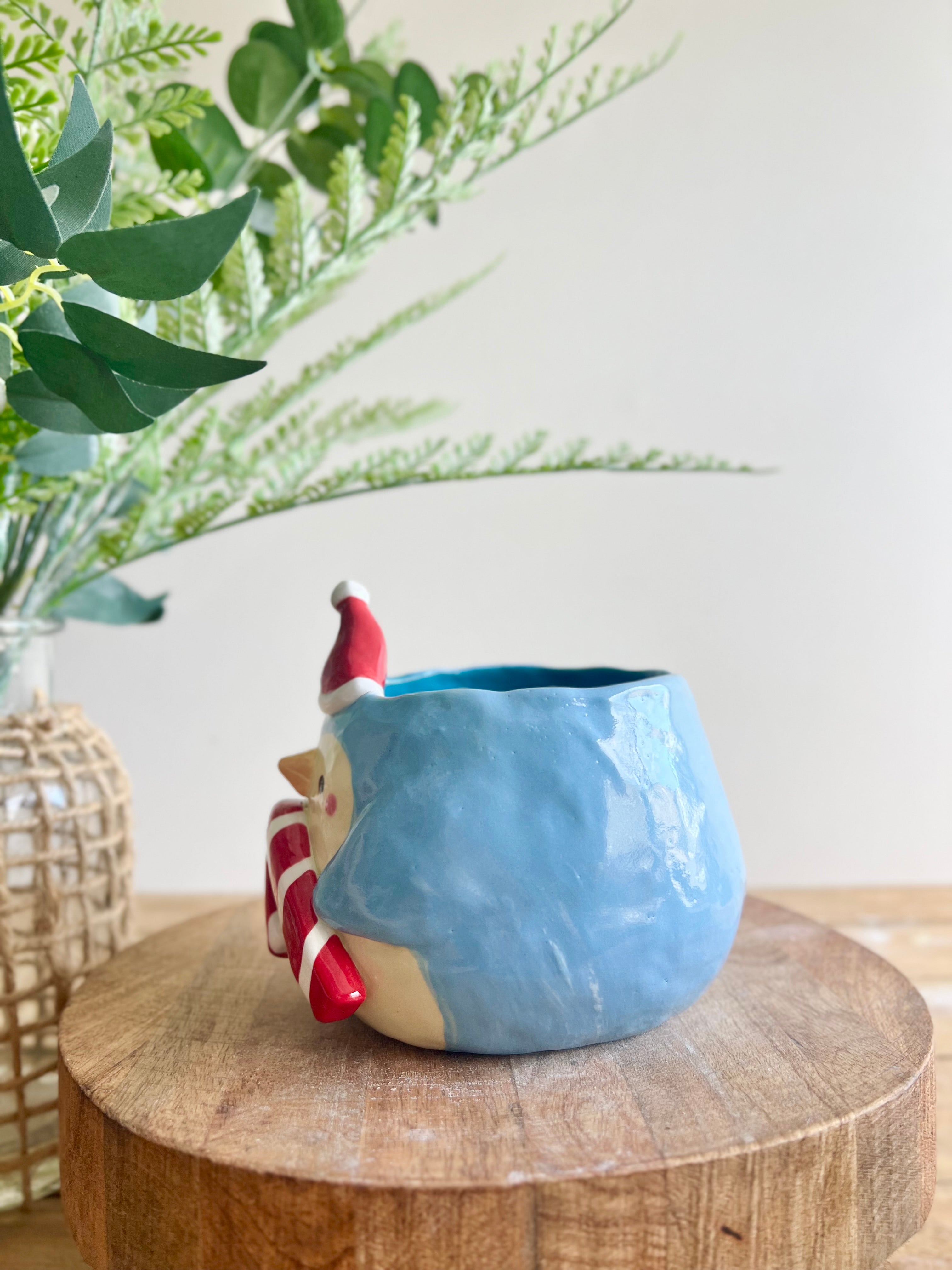 Festive penguin pot with giant candy cane friend