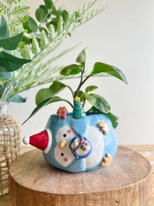 Festive sideways penguin pot with Christmas friends