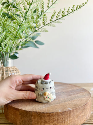 Festive grey cat with gingerbread friend bud vase