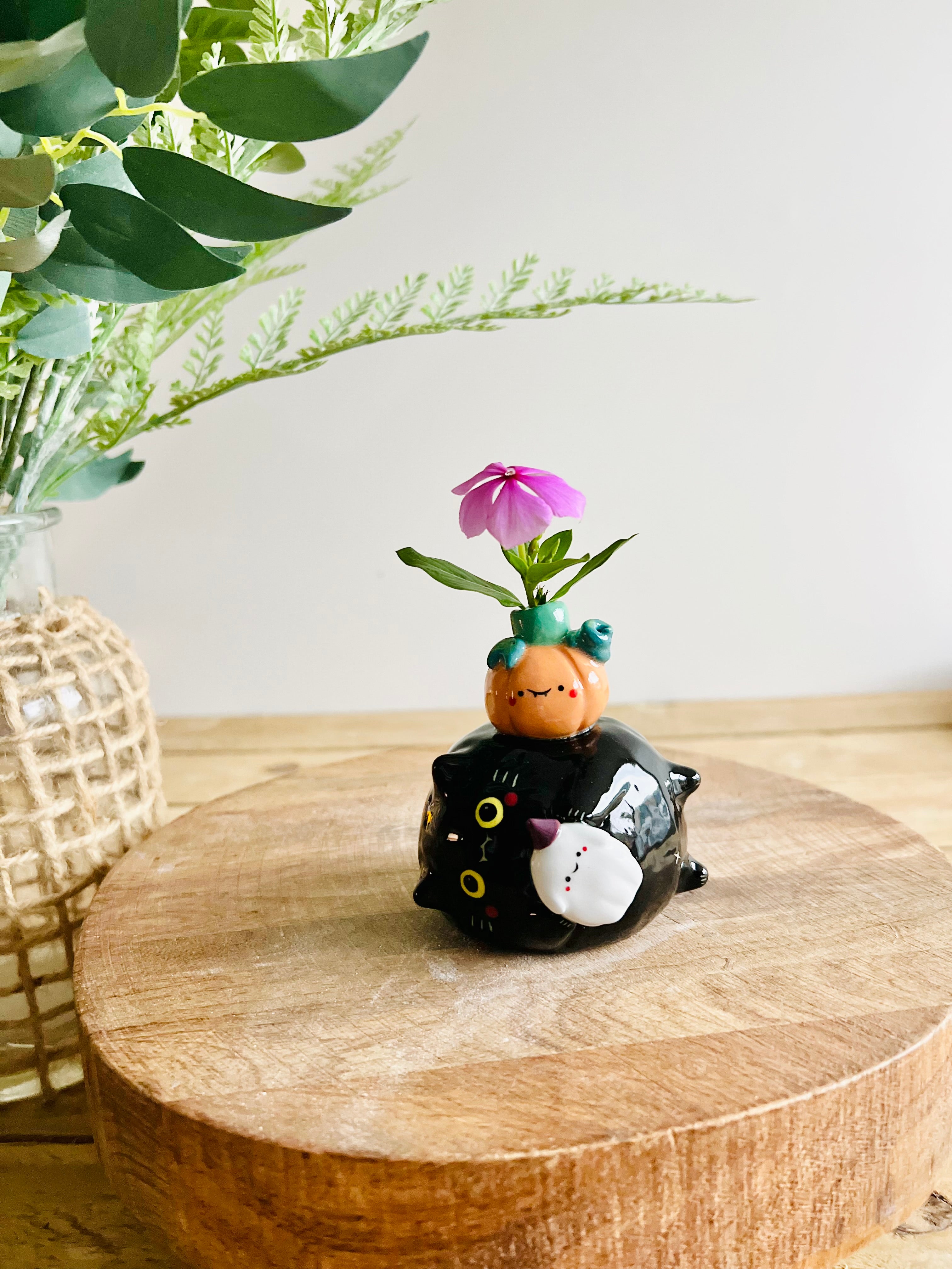 Sideways black cat with ghost and pumpkin friend bud vase