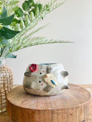 Flowery sideways bunny pot with gingerbread friend