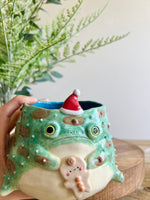 Festive grumpy Froggo planter with gingerbread friend