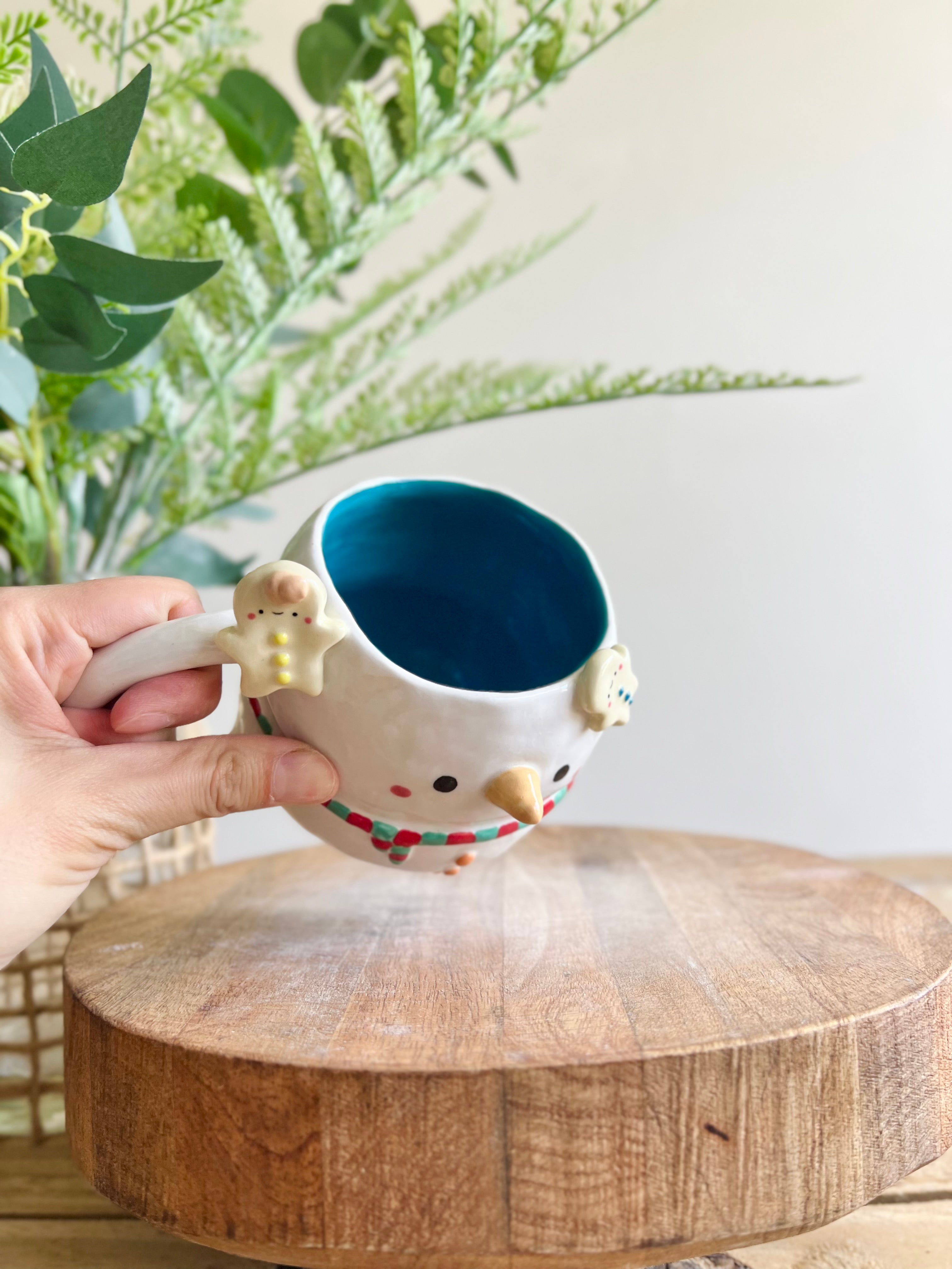 Snowman mug with gingerbread friends