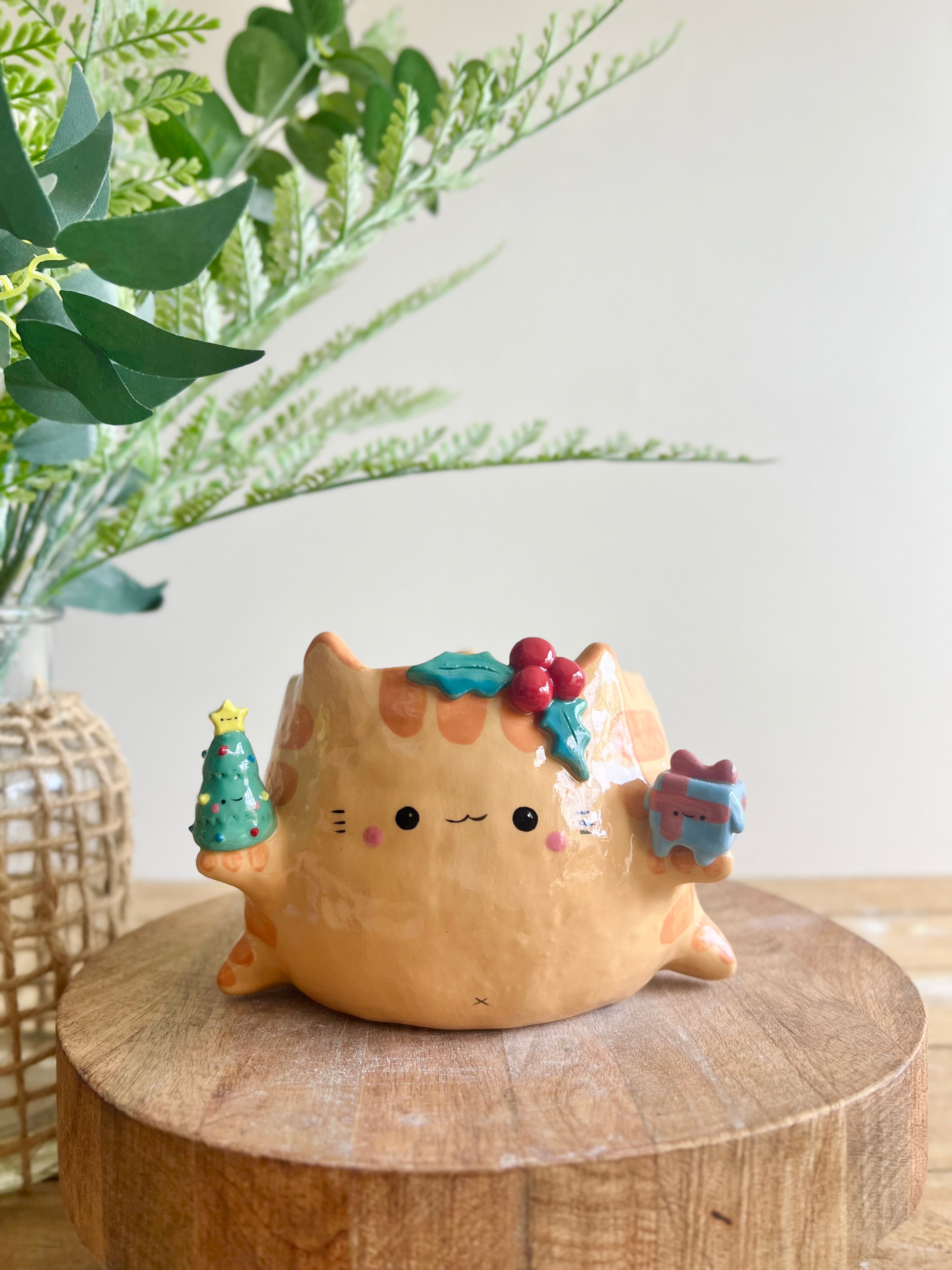 Gift bearing festive Ginger cat pot with Christmas tree friend