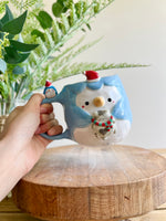 Festive Penguin mug with baby penguin and cat friend