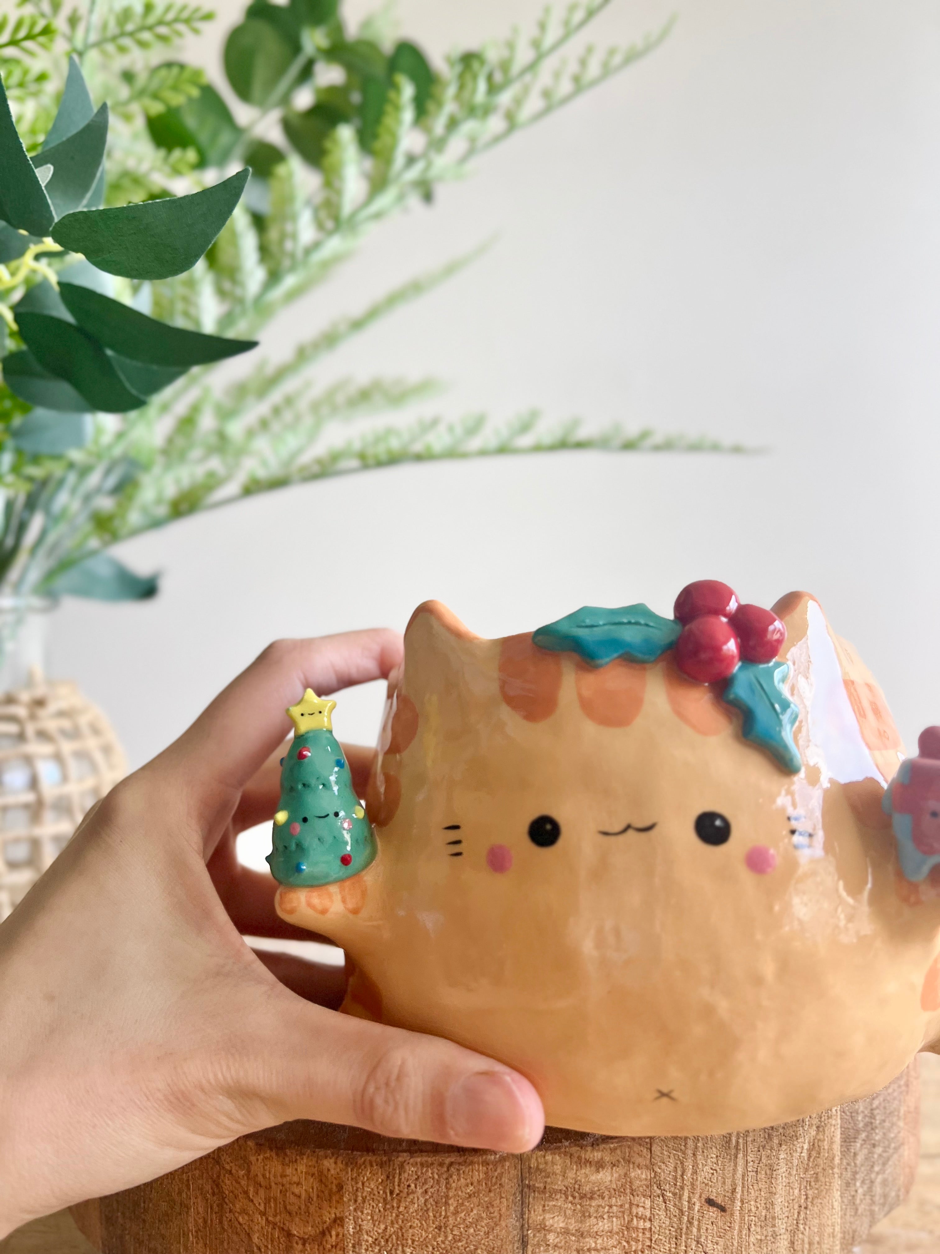 Gift bearing festive Ginger cat pot with Christmas tree friend