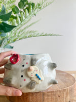 Flowery sideways bunny pot with gingerbread friend