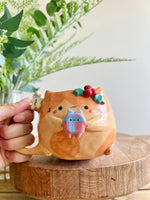 Festive gift bearing ginger cat mug with gingerbread friend