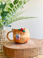 Festive gift bearing ginger cat mug with gingerbread friend