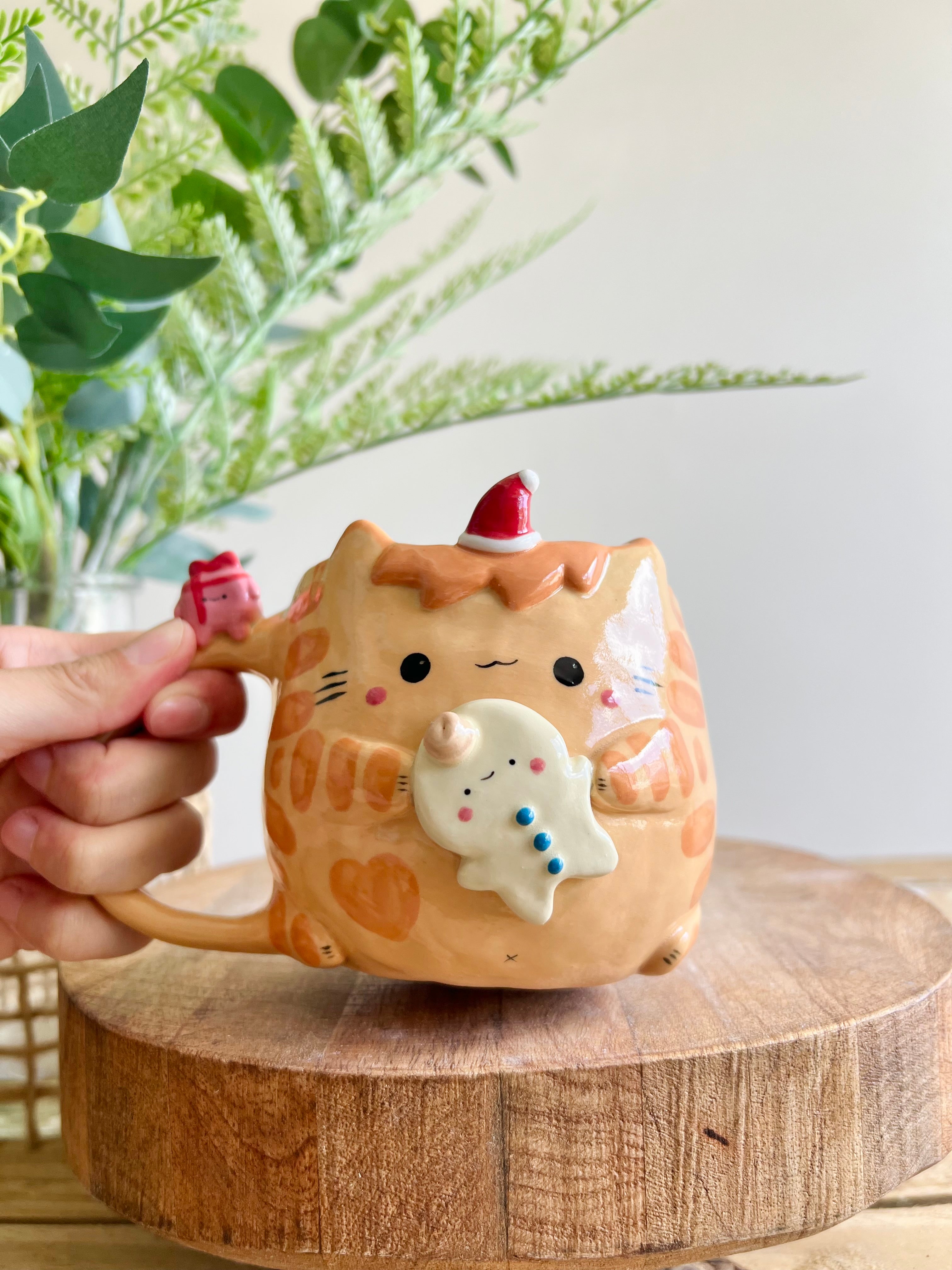 Ginger cat mug with gingerbread and present friend