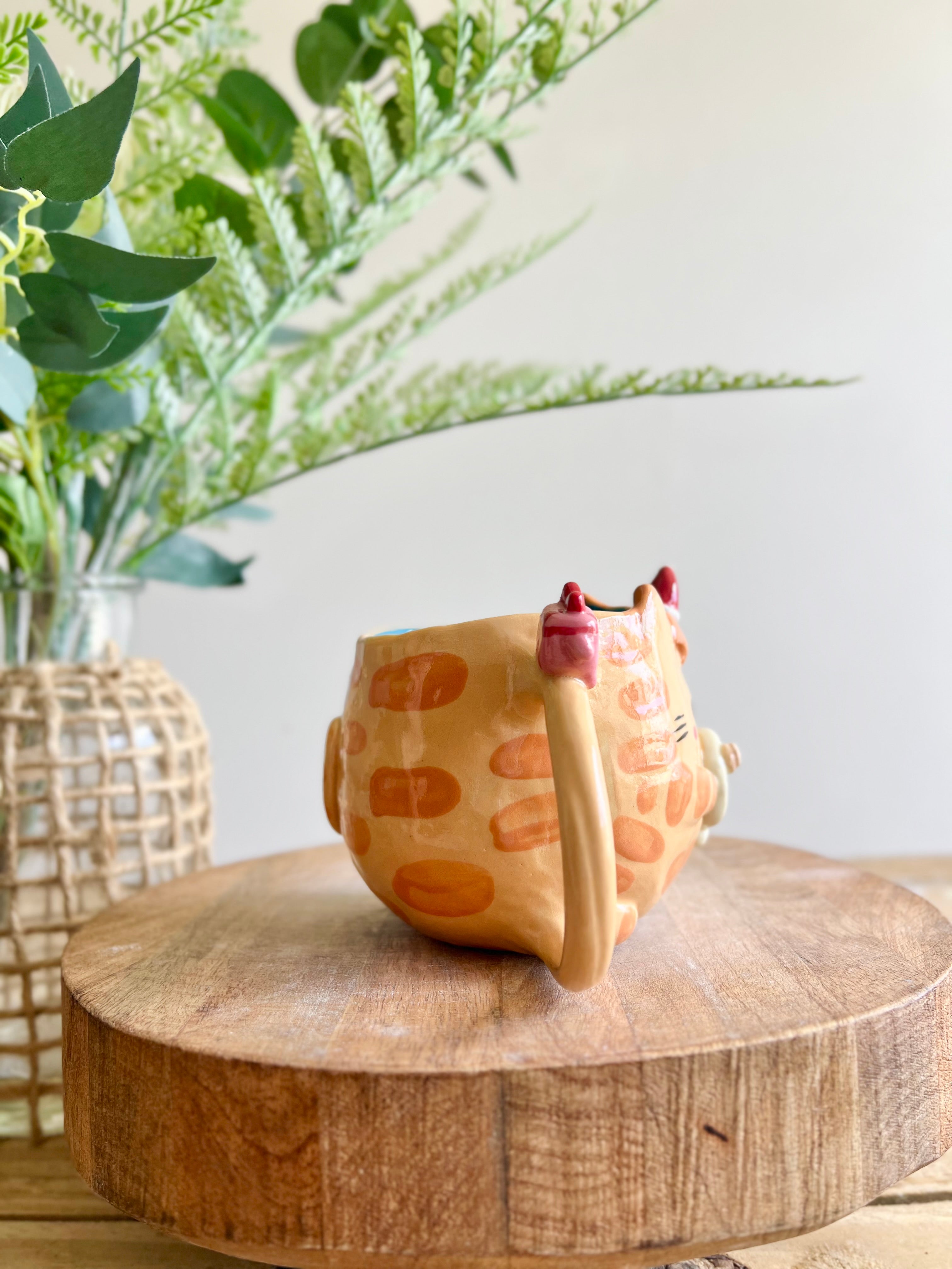 Ginger cat mug with gingerbread and present friend