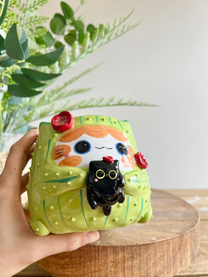 Flowery ginger CAT-us pot with black cat friend