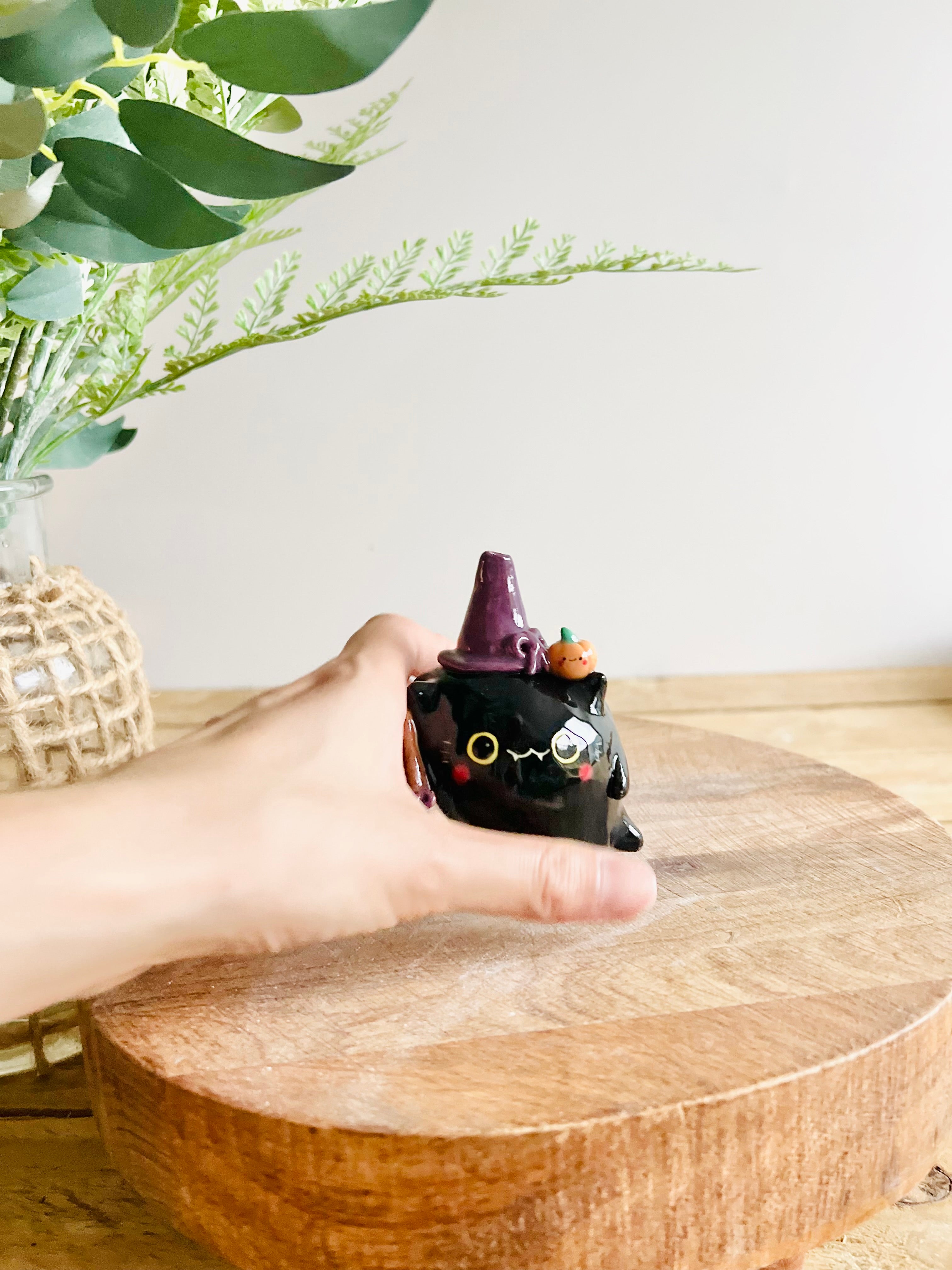 Black cat witch with broomstick and pumpkin friend bud vase