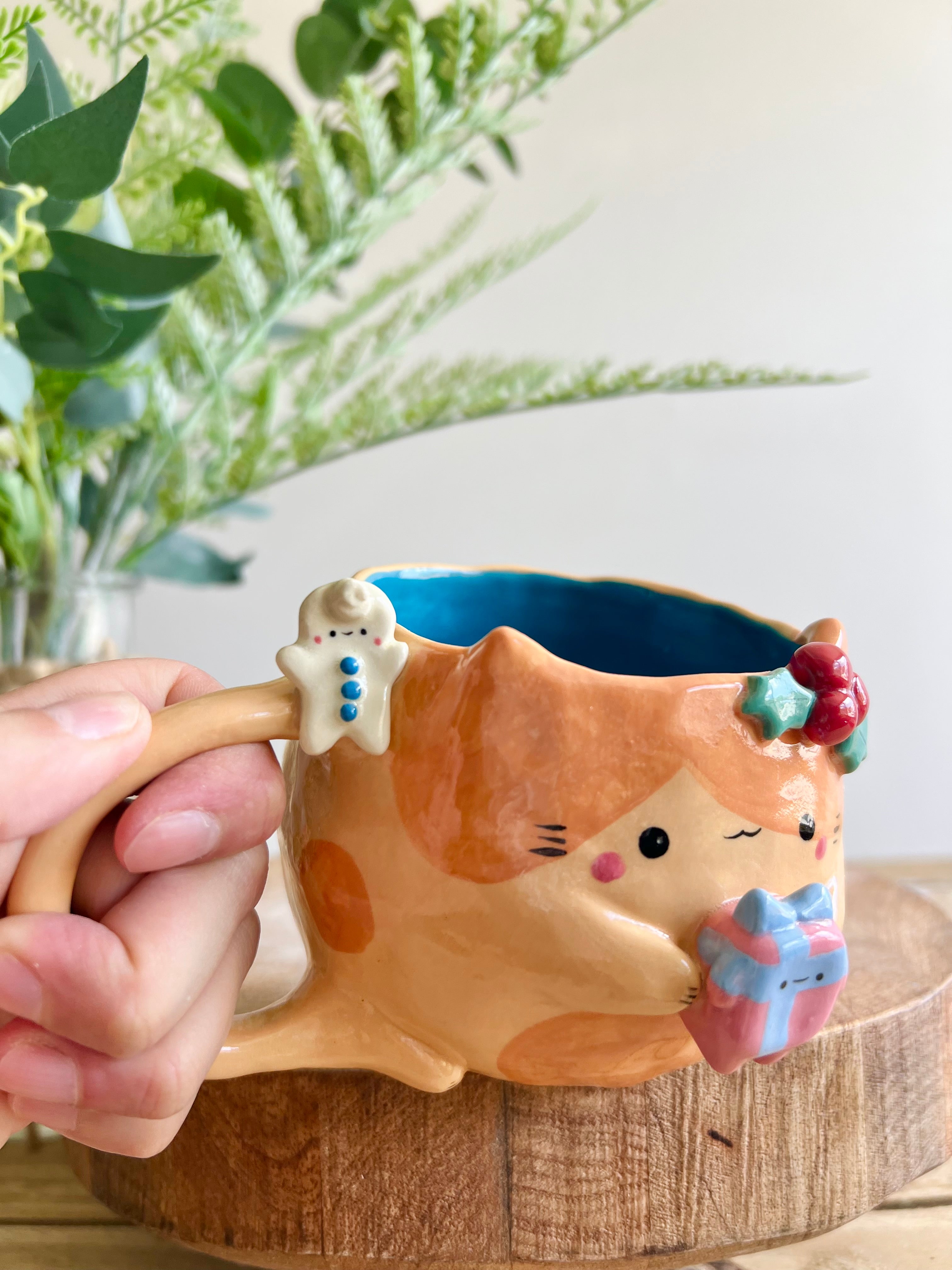 Festive gift bearing ginger cat mug with gingerbread friend