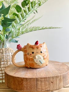 Ginger cat mug with gingerbread and present friend