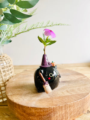 Black cat witch with broomstick and pumpkin friend bud vase